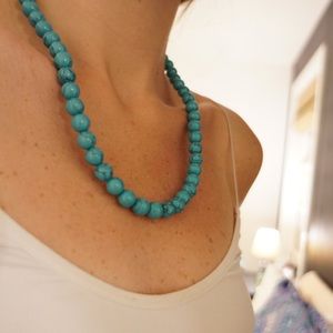 Blue beaded necklace with clasp in back